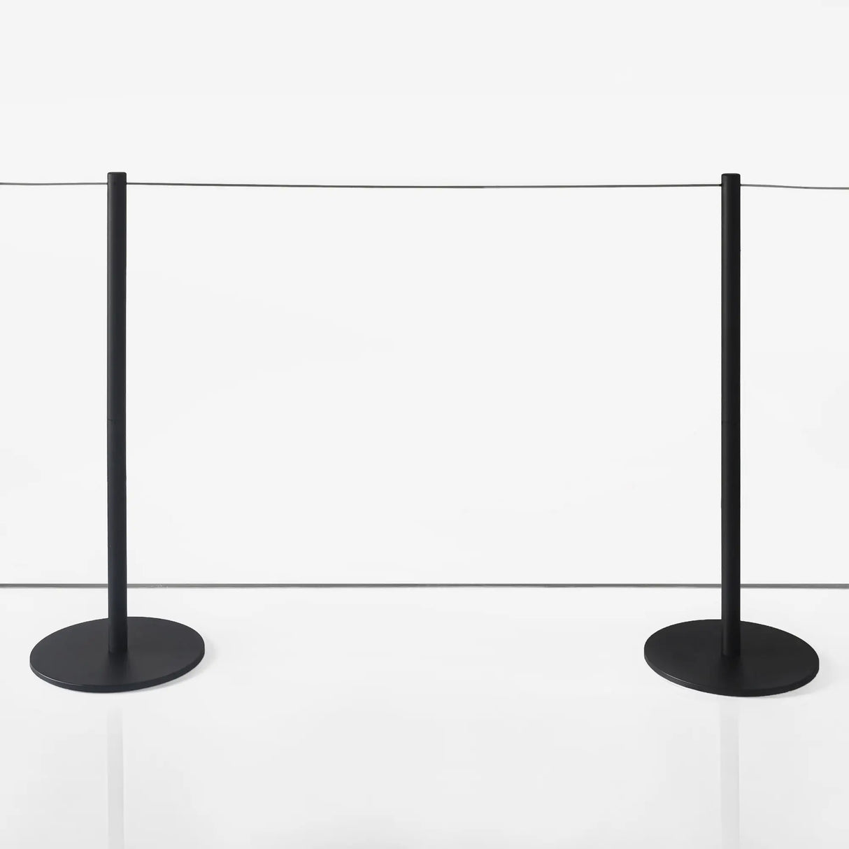black stanchion barriers with thin ropes