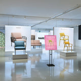 freestanding poster stand for trade shows in a showroom setting.