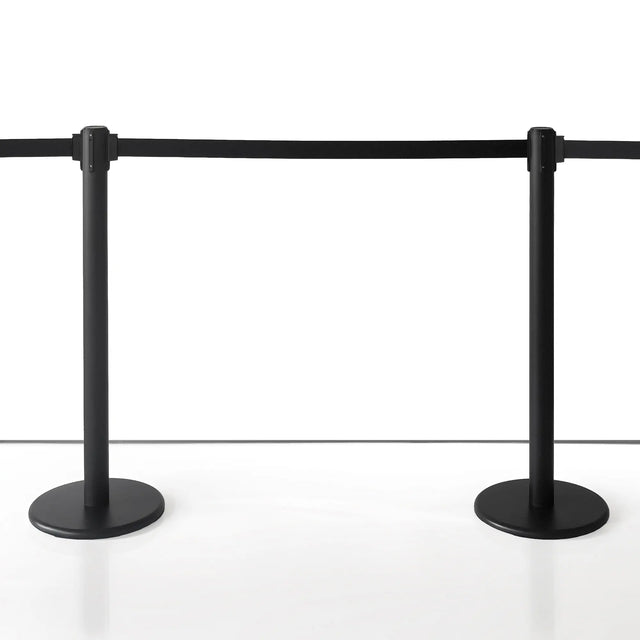 4 Way Black Stanchion with Retractable Rope in a Museum with white background setting