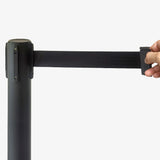 4-Way Black Stanchion with a hand pulling on the rope